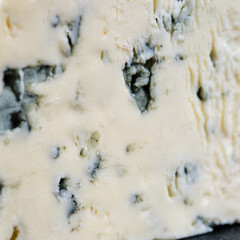 Macro photo of piece of cheese with blue mold