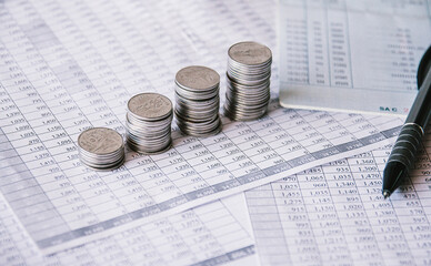 Stack of money coin on accounting sheet with selective focus, Business and financial concept. 