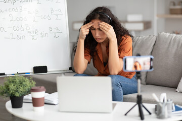 Wall Mural - Bored and tired teacher having online lesson