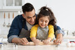 © Prostock-studio - Happy Arab Father And Little Daughter Rolling Dough Together In Kitchen