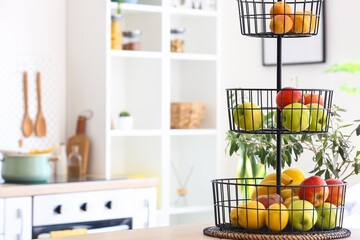 Wall Mural - Stand with healthy fruits on counter in modern kitchen