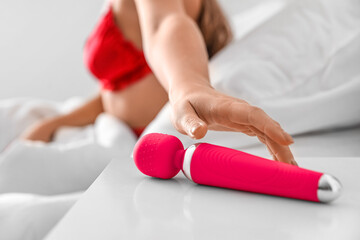 Sticker - Young woman taking vibrator from bedside table