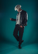 © qunica.com - Male beauty concept. Portrait of fashionable young man with stylish haircut wearing trendy glasses and sweater, posing over gray background. Perfect hair & skin. Hipster style. Copy-space. Studio shot