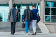 © qunica.com - Rearview of formally dressed business colleagues walking towards their workplace.