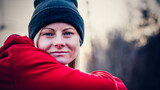Fototapeta  - Zimowy portret kobiety w czapce i czerwonej bluzie