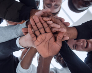 Sticker - bottom view. a group of diverse young people joining their hands together