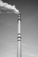 Industrial chimney smoking on sunny winter day