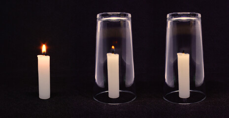 science experiment: candle lit and candle being extinguished due to lack of oxygen in cup