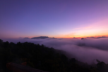 The beautiful early morning sky with twilight and waves of fog of Baan Ja Bo village viewpoint Pang Mapha, Mae Hong Son, Northern Thailand. 