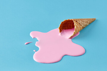 pink ice cream melting and spilling from the waffle cone. minimalistic summer food concept.