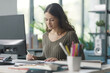 © stokkete - Professional interior designer sitting at desk and working