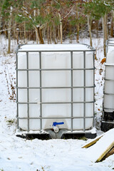 big white tank with tap for a cubic of water