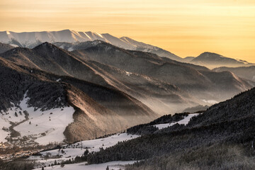 Wall Mural - Colorful evening sky over snowy winter mountains. VIllage Biely Potok and Low Tatras mountains at Slovakia