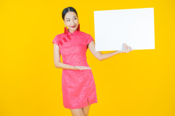 Wall Mural - Portrait beautiful young asian woman with empty white billboard