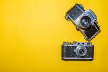 Old Cameras On A Yellow Background. Photo Camera For Home