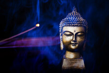 Buddha Next To Incense Smoke