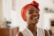 © Rido - Cheerful african woman wearing trendy red headscarf