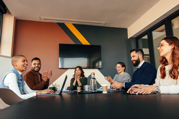 Wall Mural - Successful businesspeople applauding their colleague