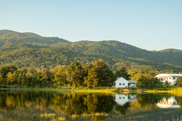 The scenery of a white house beside the lake