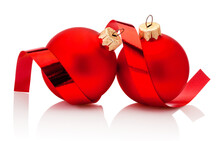 Two Red Christmas Baubles And Curling Paper Isolated On White Background
