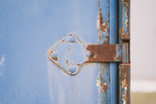 Door Hinge On The Garage Door. Old Rusty Metal Door Hinge.
