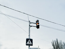 Traffic Light And Pedestrian Crossing Sign On A Pole Against The Sky.