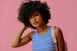 © Carlos David - beautiful young african american female student in eyeglasses posing on pink background