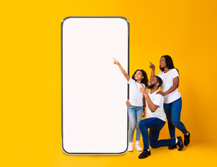 Black family showing blank empty smartphone screen for mockup
