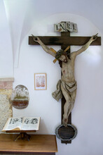 Statue Of The Crucified Christ  In The Cathedral And The Old  Holy Open Book. Christian Symbolism. 
