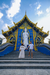 Blue Temple Chiang Rai Thailand, Rong Sua Ten temple, Chiang Rai Blue Temple, or Wat Rong Seua Ten is located in Rong Suea , couple visit a temple in Thailand, man and woman vacation Asia