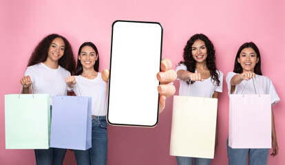 happy ladies showing blank empty smartphone screen for mockup