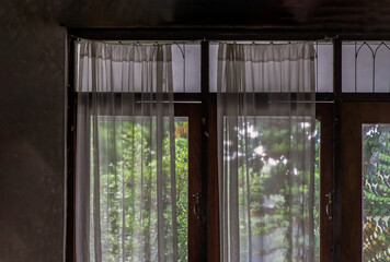 Wall Mural - Wooden simple glass of Windows and White lace curtains with sunlight that shines through in traditional thai house, Thai Style architecture, No focus, specifically.