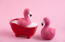 Funny Pink Flamingoes And  Bath With Foam On A Pink Background.