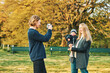 © annanahabed - Photographer taking film pictures of young moder with toddler girl in autumn or spring park