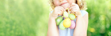 Cute Funny Girl With Easter Eggs And Bunny Ears At Garden. Easter Concept. Laughing Child At Easter Egg Hunt. Child In Park With Basket Full Of Eggs, Spring Concept