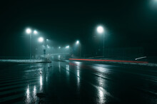 Lights Of The Car On The Street Of The City At Night In The Fog