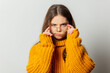 © Masson - Beautiful girl in glasses and yellow sweater on white background