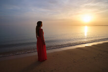 Lonely Young Woman Standing On Ocean Beach By Seaside Enjoying Warm Tropical Evening