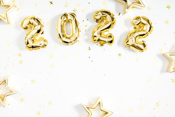 Wall Mural - Happy New Year 2022. Foil gold balloons in form of numbers 2022. New year celebration. Gold Air Balloons on white background. Flat lay, top view, copy space