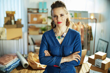 Young Small Business Owner Woman In Office In Blue Overall