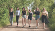 © Довидович Михаил - Schoolgirl friends are walking outside the city along a forest road.