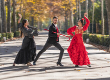 Man With Two Female Flamenco Dancers Dancing On A Park