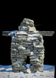 Inuksuk (also spelled inukshuk, plural inuksuit) is a figure made of piled stones or boulders constructed to communicate with humans throughout the Arctic. Traditionally constructed by the Inuit, inuk