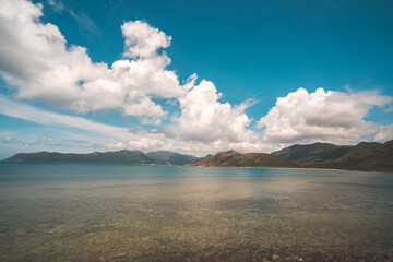 	
Panoramic coastal Con Dao view from above, with waves, coastline ,clear sky and road, blue sea and mountain.