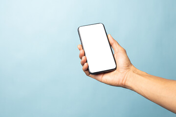 Hand business man holding mobile smartphone with blank screen isolated on blue background with clipping path