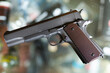 Pistol on showcase in weapon shop. Exemplar of firearm weapon.