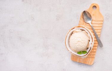 Fototapete - Coconut ice cream flavours in half of coconut setup on white stone background. Summer and Sweet menu concept.