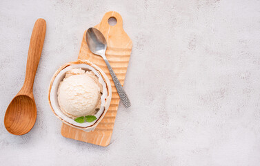 Fototapete - Coconut ice cream flavours in half of coconut setup on white stone background. Summer and Sweet menu concept.