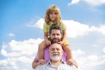 Wall Mural - Portrait of men generation grandfather father and grand son outdoor on sky. Fathers day concept. Men in different ages. Funny men faces.