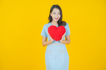 Poster - Portrait beautiful young asian woman smile with heart pillow shape